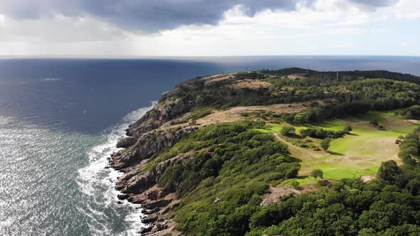 Forward going drone view of Kullaberg from high up, summer time