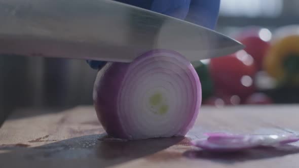 Red Onion Cut By the Knife on the Cooking Board