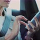 Closeup of Woman Hands Texting and Using Smartphone Device in Back Seat Car - VideoHive Item for Sale