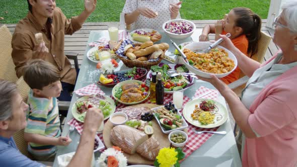 Family eating outside together in summer