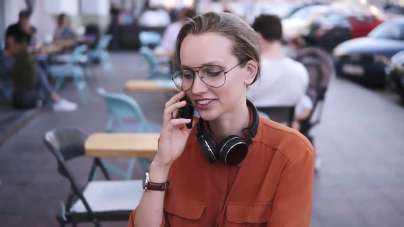 Smartphone Woman Talking on Phone While Sitting in Cafe