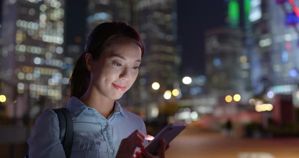 Woman use of mobile phone at city