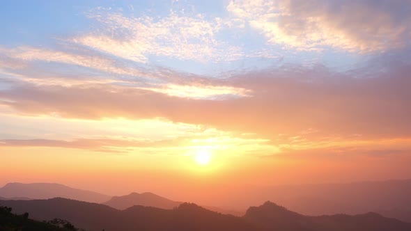 4K : Timelapse of clouds moving at sunset over beautiful mountains.