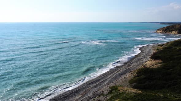 Aerial View of Cyprus Seaside. Waves of Blue Calm Mediterranean Sea Rolling on Wet Pebble Beach. Sea