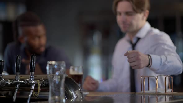 Blurred Caucasian Man Taking Car Key From Bar Counter As African American Friend Stops Mate From