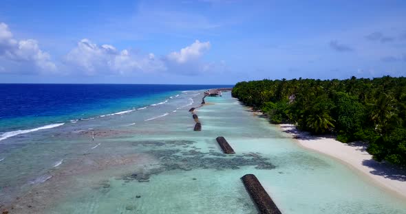 Luxury overhead travel shot of a paradise sunny white sand beach and blue water background in high r