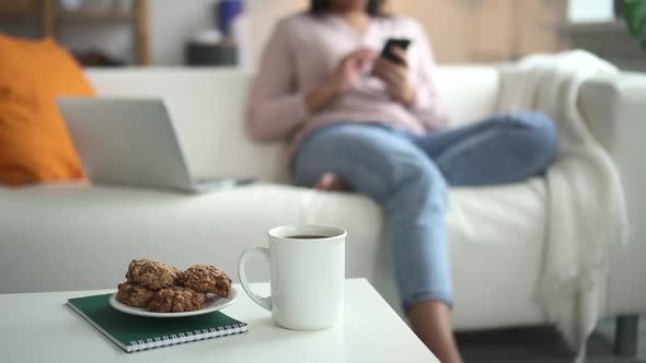 Woman Using Smartphone and Sitting on Sofa in Home Room During Pandemic Spbd