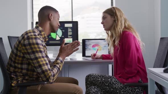 man and woman working on computers