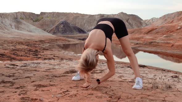Woman working out on lifeless dried locality