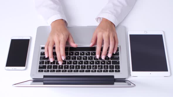 Closeup of Woman's Hands Using Laptop. Tablet. Close Up