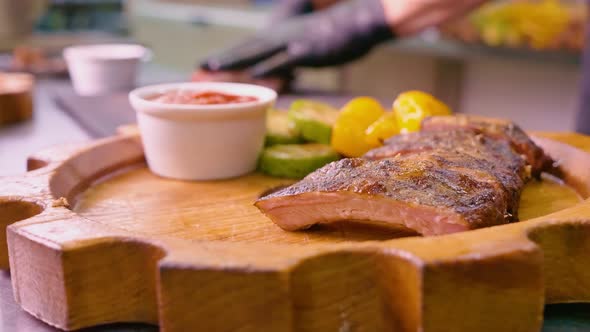 Juicy Grilled Pork Ribs are Served By the Chef on a Decorative Wooden Tray