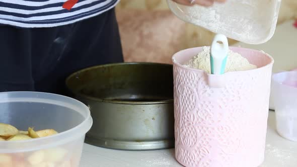 A Woman Makes Dough For An Apple Pie. Cooking Charlotte At Home.