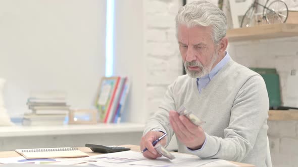 Old Man Controlling Finance Separating Dollars