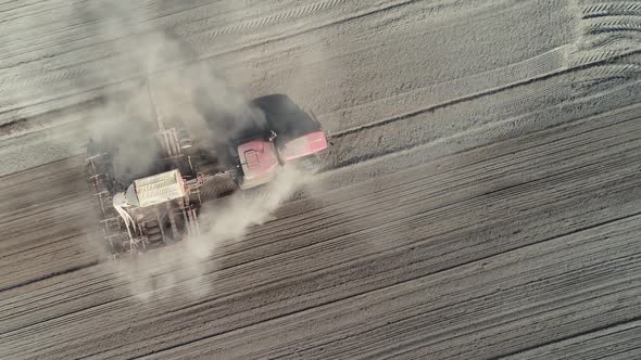 Countryside and Agriculture, Farm Tractors Plow the Earth in Field, Dust in the Field, View From