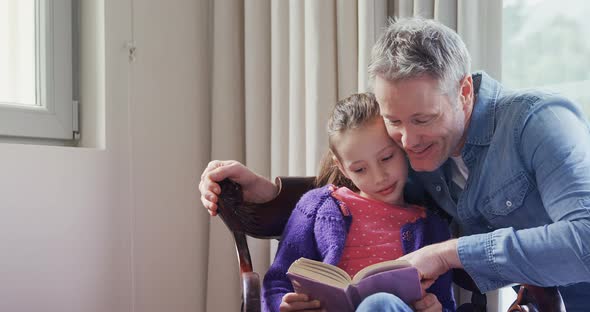 Father and daughter reading a book 4k