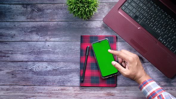 High Angle View of Man Hand Using Smart Phone with Green Screen 