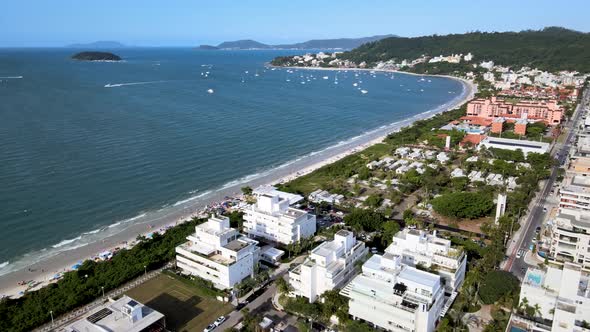 Aerial drone view of urbanized tropical luxury beach with oceanfront summer houses in florianópolis