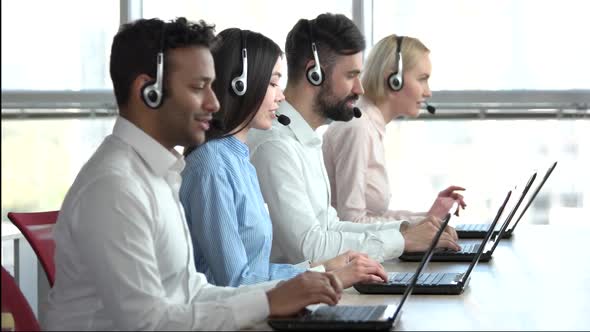 Operators with Headsets in Bright Office.