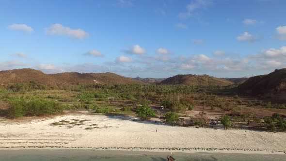 Aerial view of tropical beach with a traditional boat, Lombok, Indonesia.