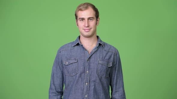 Young Man Against Green Background