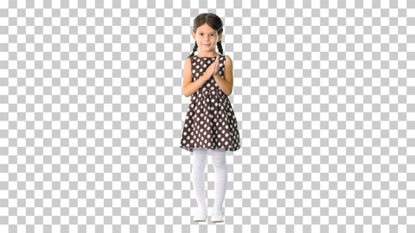 Little girl in polka dot dress clapping, Alpha Channel