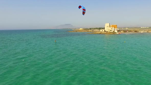 A man kiteboarding on a hydrofoil kite board