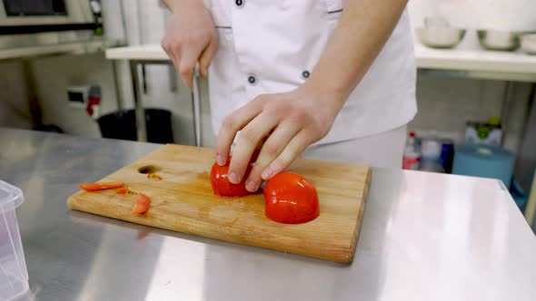 Slicing a Tomato on a Wooden Tray