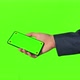 Business man hand shows mobile smartphone with green screen - VideoHive Item for Sale