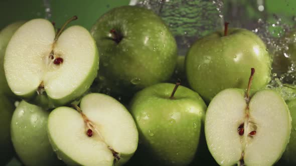 Slow Motion Shot of Green Apple Water Splashing Through Apple Slices