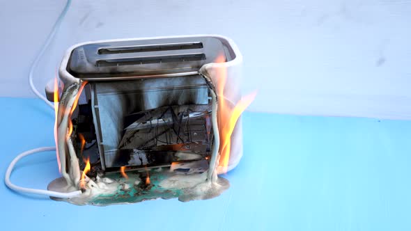 Toaster on Fire. Household Electrical Appliance Fire Hazard.