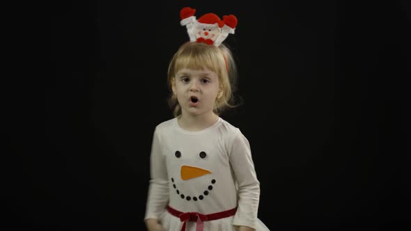 Happy Beautiful Baby Girl in Snowman Costume. Christmas. Make Faces, Dance