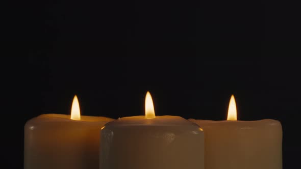 Burning Wax Candles on Black Chroma Key Background