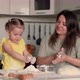 Happy Mom and Daughter are Preparing Pastries From Dough and Flour in the Kitchen at the Table - VideoHive Item for Sale