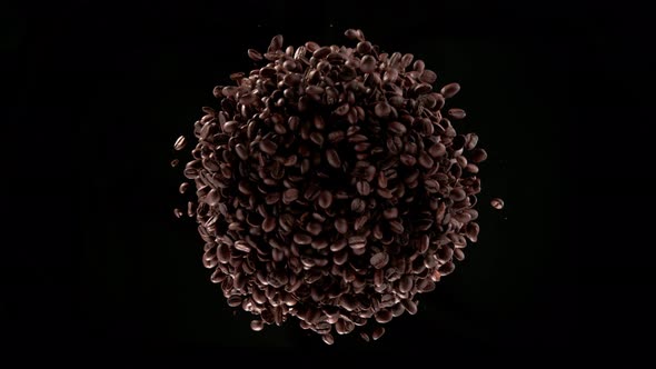 Super Slow Motion Shot of Rotating and Exploding Premium Coffee Beans Isolated on Black at 1000Fps