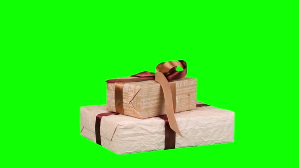 Beautifully Wrapped Gifts, Presents Isolated on Green Background. Close-up, Rotation. Christmas or