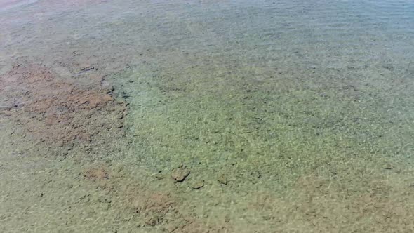 Beautiful aerial footage of the clear ocean sea off the coast of Greece in Corfu