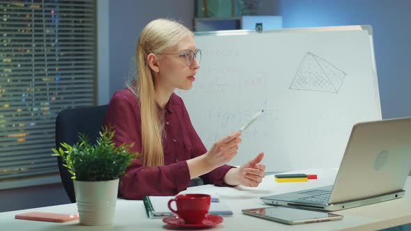 Business Woman Explaining Information to Somebody By Video Call Using Whiteboard