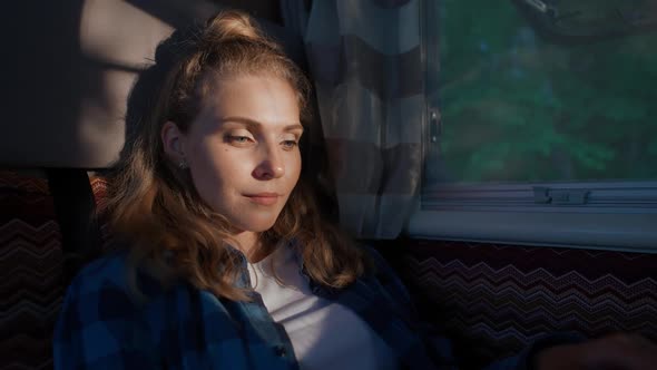 Young Woman Freelancer Working at a Laptop While Sitting in a Car Typing Text and Remote Work in