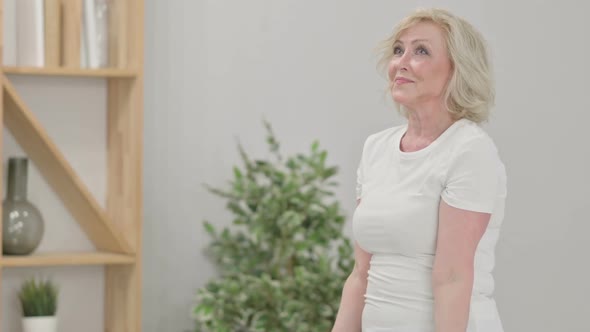 Sporty Old Woman Working Out with Dumbbells at Home