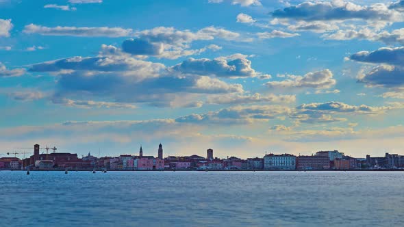 Vessels Sail on Blue Venetian Lagoon Against Historic City