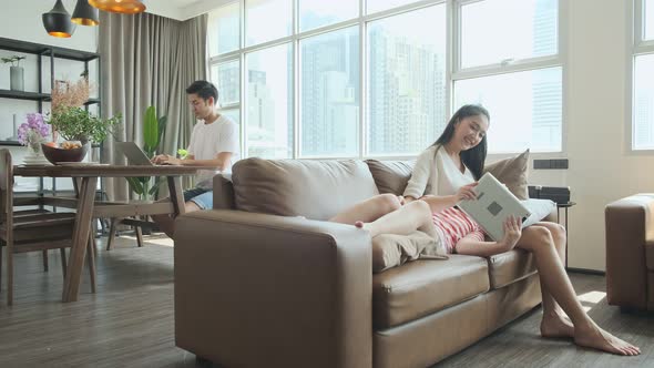 asian family enjoy weekend home sweet home,father working at home with mother