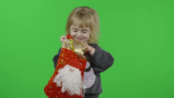 Happy Beautiful Little Girl in a Sweater with a Snowman. Christmas. Chroma Key