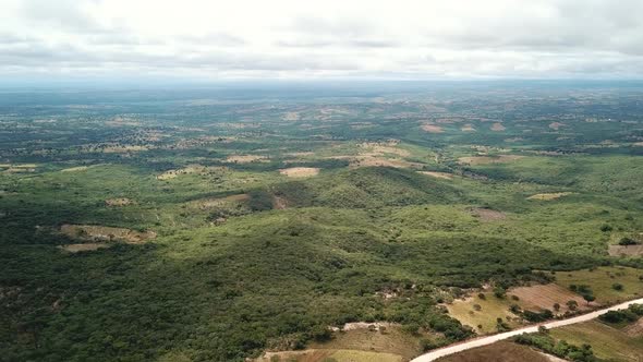 Aerial View of the Green Plains in Mountains and Trafic Road, Tanzania, Africa. The the Green Hills