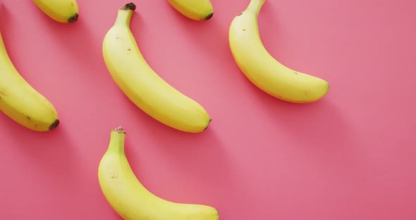 Video of fresh bananas with copy space on pink background