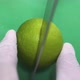 Chef Cuts Tasty Sour Lime on Green Board in Kitchen Closeup - VideoHive Item for Sale