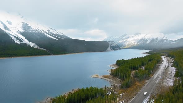 Drone footage of green forest on the shore of Spray Lakes Reservoir in Alberta, Canada