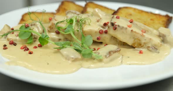 Potato babka savoury dish, popular in Belarus and Poland garnish with mushroom creamy sauce and red