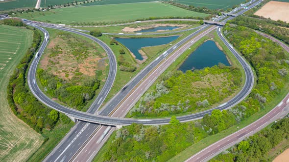 Beautiful top view time-lapse of car traffic at roundabout lane.