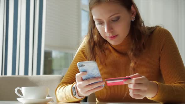 Beautiful Sunny Day Young Woman Drinks Morning Coffee in a Cafe, Making Online a Purchase Easy