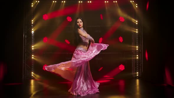 Young Girl in Posh Oriental Costume Is Passionate Wriggles in Dance, Demonstrating the Grace